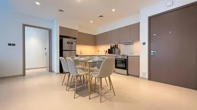 a kitchen with a table and chairs in a room at Premium 2bed Apartment In Downtown Act1 Tower in Dubai