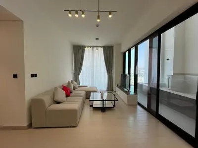 a living room with a couch and a table at Binghatti Amber in Dubai