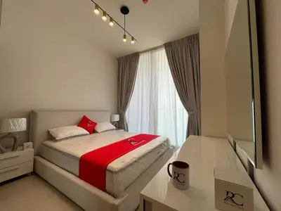 a small bedroom with a bed and a window at Binghatti Amber in Dubai