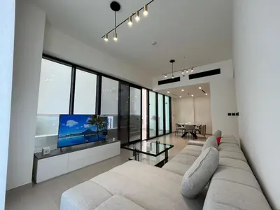 a living room with a couch and a flat screen tv at Binghatti Amber in Dubai