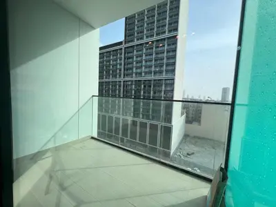 a balcony with a view of a tall building at Binghatti Lavender in Dubai