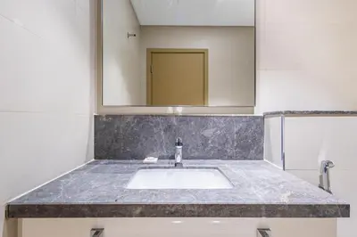 a bathroom with a sink and a mirror at Superhost- Elegant Downtown 3BR , Burj Khalifa View in Dubai