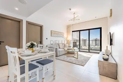 a living room with a table and a couch at Trendy 1BR with a Glimpse of Burj Khalifa, Near Zabeel Stadium, Minutes Drive to Dubai Frame, Binghatti Creek, Al Jaddaf by Deluxe Holiday Homes in Dubai