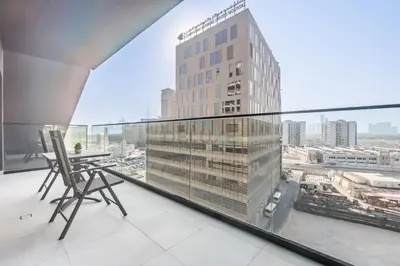 a balcony with a view of a tall building at Trendy 1BR with a Glimpse of Burj Khalifa, Near Zabeel Stadium, Minutes Drive to Dubai Frame, Binghatti Creek, Al Jaddaf by Deluxe Holiday Homes in Dubai