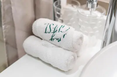 a towel with writing on it sitting on a bathroom sink at Palm Jumeirah, panoramic free pool,beach in Dubai