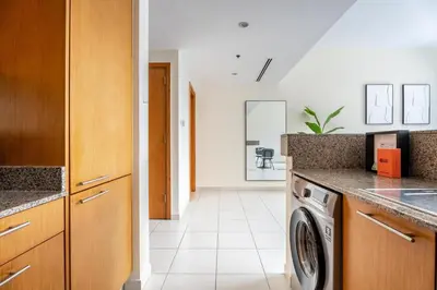 a kitchen with a washer and dryer at GuestReady - Prime Location Stay | Business Bay in Dubai