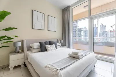 a bedroom with a large bed and a large window at GuestReady - Prime Location Stay | Business Bay in Dubai