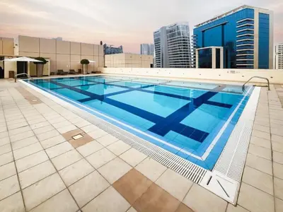 a large swimming pool on top of a building at GuestReady - Prime Location Stay | Business Bay in Dubai