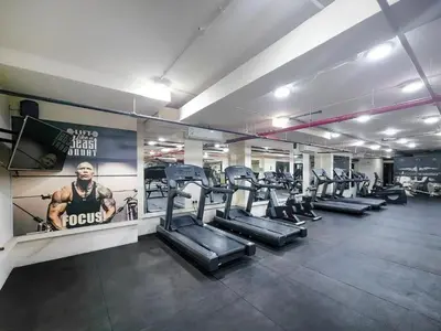 a gym with rows of treadmills and cardio machines at GuestReady - Prime Location Stay | Business Bay in Dubai