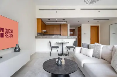 a living room with a couch and a table at GuestReady - Prime Location Stay | Business Bay in Dubai