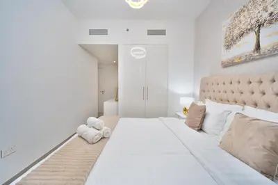 a large white bedroom with a large white bed at Executive 2-Bedroom Apartment in Downtown views 2 with access to Dubai mall in Dubai