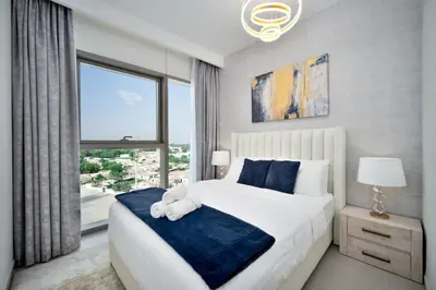 a bedroom with a large bed and a large window at Executive 2-Bedroom Apartment in Downtown views 2 with access to Dubai mall in Dubai