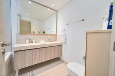 a bathroom with a sink and a mirror and a toilet at Executive 2-Bedroom Apartment in Downtown views 2 with access to Dubai mall in Dubai