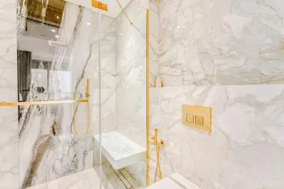 a bathroom with a shower with a glass door at PVH - Emaar Residence Fashion Avenue - Burj Khalifa View Studio in Dubai