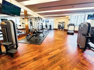 a gym with a woman exercising in a gym at PVH - Emaar Residence Fashion Avenue - Burj Khalifa View Studio in Dubai