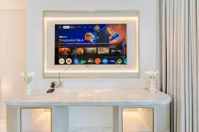 a tv on a wall in a living room at PVH - Emaar Residence Fashion Avenue - Burj Khalifa View Studio in Dubai