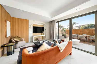 a living room with a couch and a tv at FIRST CLASS VILLA Hidden Luxury Gem in Dubai