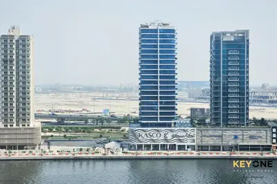 a view of a city with tall buildings and water at Majestine Living Stylish Studio with Canal View in Dubai