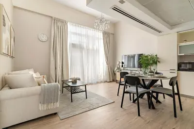 a living room with a couch and a table at FIRST CLASS 2BR Luxe & Lively Living in Dubai