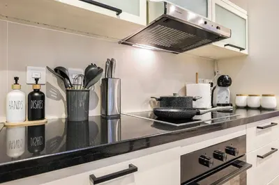 a kitchen with a counter top with a stove at FIRST CLASS 2BR Luxe & Lively Living in Dubai