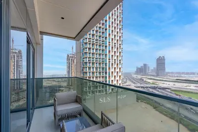 a balcony with a view of a building at Samaya Holiday Homes - Modern Luxe Apartments - Nobles Tower in Dubai