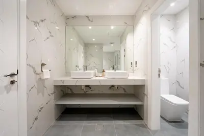 a bathroom with two sinks and a mirror and a toilet at Private Marina 5 Master Bedrooms & Private Pool in Dubai