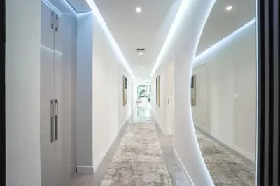 a hallway with white walls and a carpet at Private Marina 5 Master Bedrooms & Private Pool in Dubai