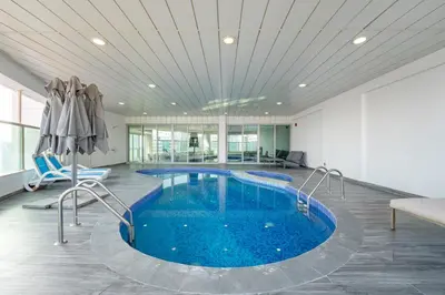 a large swimming pool in a room with a large ceiling at Private Marina 5 Master Bedrooms & Private Pool in Dubai