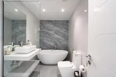 a bathroom with a tub and a sink and a toilet at Private Marina 5 Master Bedrooms & Private Pool in Dubai