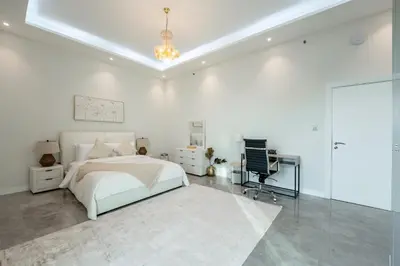 a white bedroom with a bed and a desk at Private Marina 5 Master Bedrooms & Private Pool in Dubai