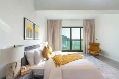 a bedroom with a large white bed and a lamp at Private Marina 5 Master Bedrooms & Private Pool in Dubai