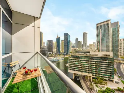 a balcony with a view of a city skyline at Modern 1BR Apt With Access to Jacuzzi, Sauna & Pool in Dubai