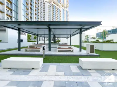 a pavilion with benches and tables in a building at Luxury 1-Bed in Meydan with Balcony & City Views in Dubai