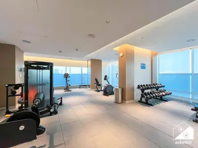 a gym with treadmills and exercise equipment in a building at Modern 1B Luxury , Scenic City Balcony, Pool & Gym in Dubai