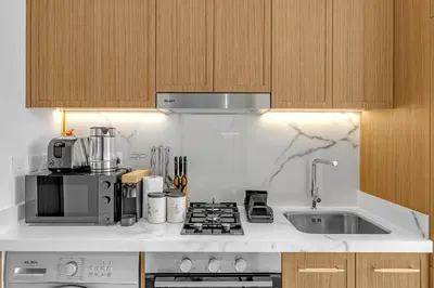 a kitchen with a sink and a stove top oven at Vibrant Studio Your Perfect Stay Awaits in Dubai