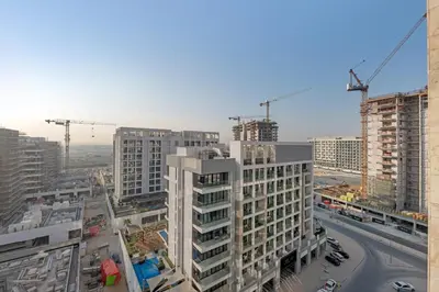 an aerial view of a city with construction cranes at Vibrant Studio Your Perfect Stay Awaits in Dubai