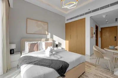 a bedroom with a bed with two stuffed animals on it at Vibrant Studio Your Perfect Stay Awaits in Dubai