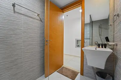 a bathroom with a sink and a glass shower at Golden Woods Escape Near Marina & JBR in Dubai