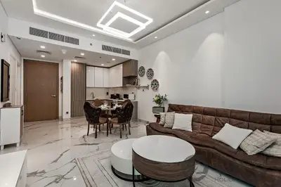a living room with a couch and a table at Stylish 1 bedroom in Pinnacle, Dubai Hills in Dubai