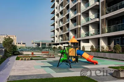 a playground in front of a apartment building at Stylish 1 bedroom in Pinnacle, Dubai Hills in Dubai