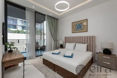 a bedroom with a bed and a desk and a window at Stylish 1 bedroom in Pinnacle, Dubai Hills in Dubai