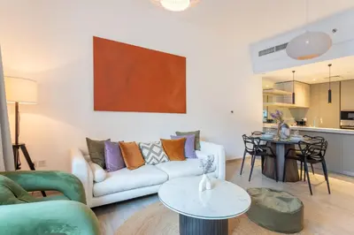 a living room with a couch and a table at Vacationer l Upgraded 1 Bedroom l near Circle Mall in Dubai