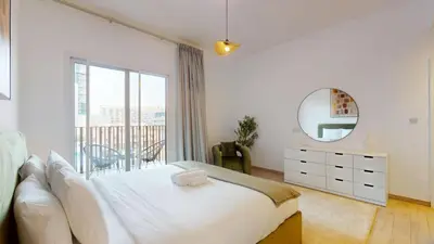 a bedroom with a white bed and a mirror at Vacationer l Upgraded 1 Bedroom l near Circle Mall in Dubai