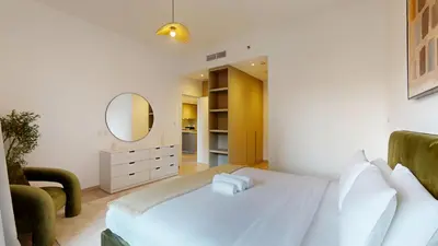 a bedroom with a white bed and a mirror at Vacationer l Upgraded 1 Bedroom l near Circle Mall in Dubai