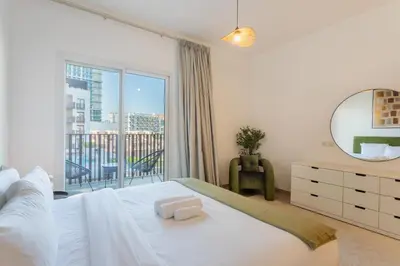 a bedroom with a bed and a large window at Vacationer l Upgraded 1 Bedroom l near Circle Mall in Dubai