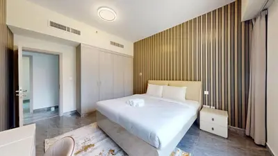 a bedroom with a large white bed and a window at Rimal - Upgraded Three Plus Kids Bedroom in JBR in Dubai