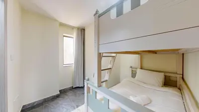 a small bedroom with a bunk bed and a window at Rimal - Upgraded Three Plus Kids Bedroom in JBR in Dubai