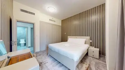 a bedroom with a white bed and a desk at Rimal - Upgraded Three Plus Kids Bedroom in JBR in Dubai
