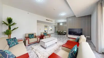a living room with a couch and a tv at Rimal - Upgraded Three Plus Kids Bedroom in JBR in Dubai
