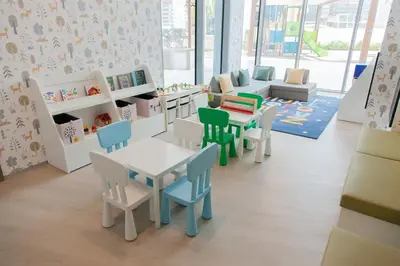 a childrens room with tables and chairs and a table at Royal suites LIv Marina views in Dubai